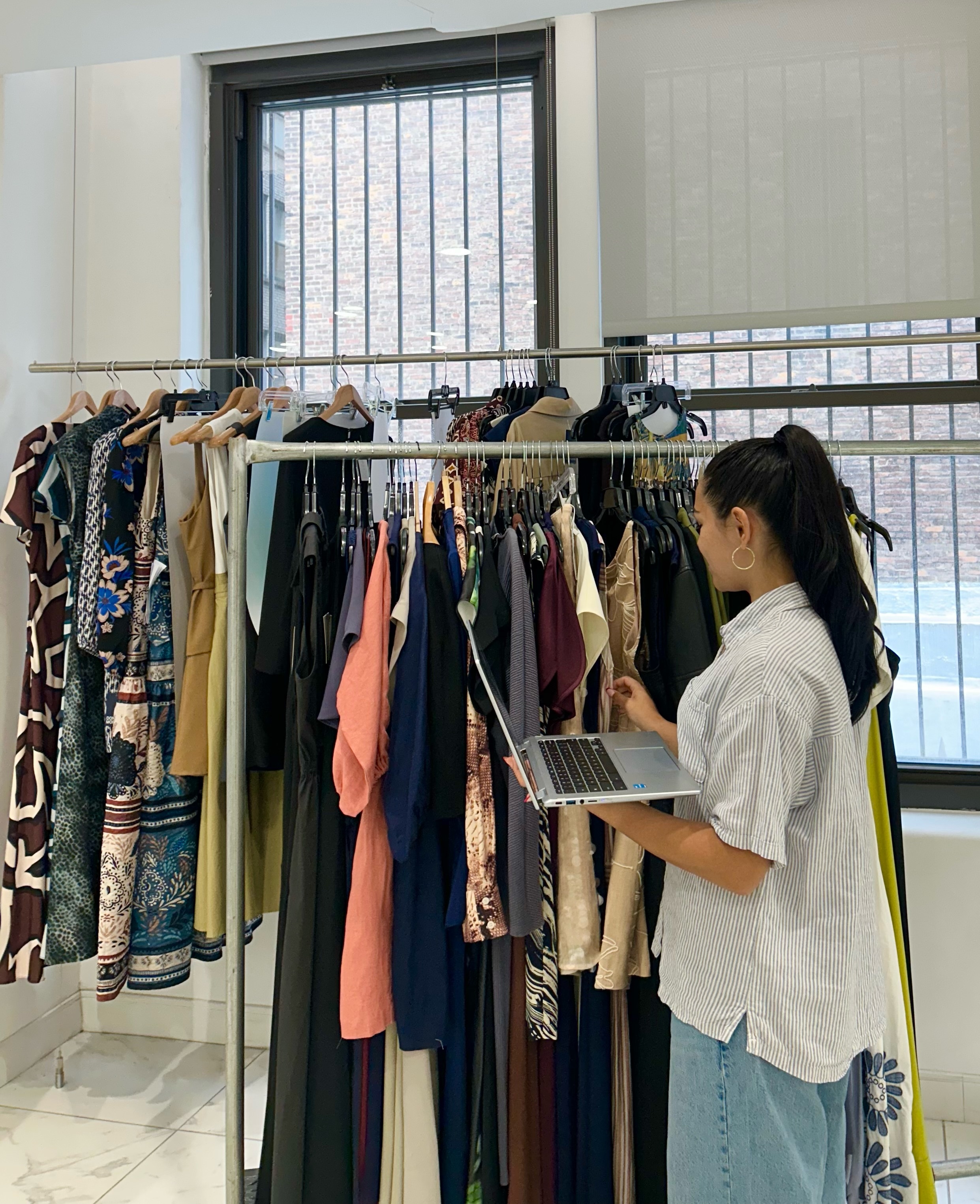 Intern reviewing garments in the NYC showroom